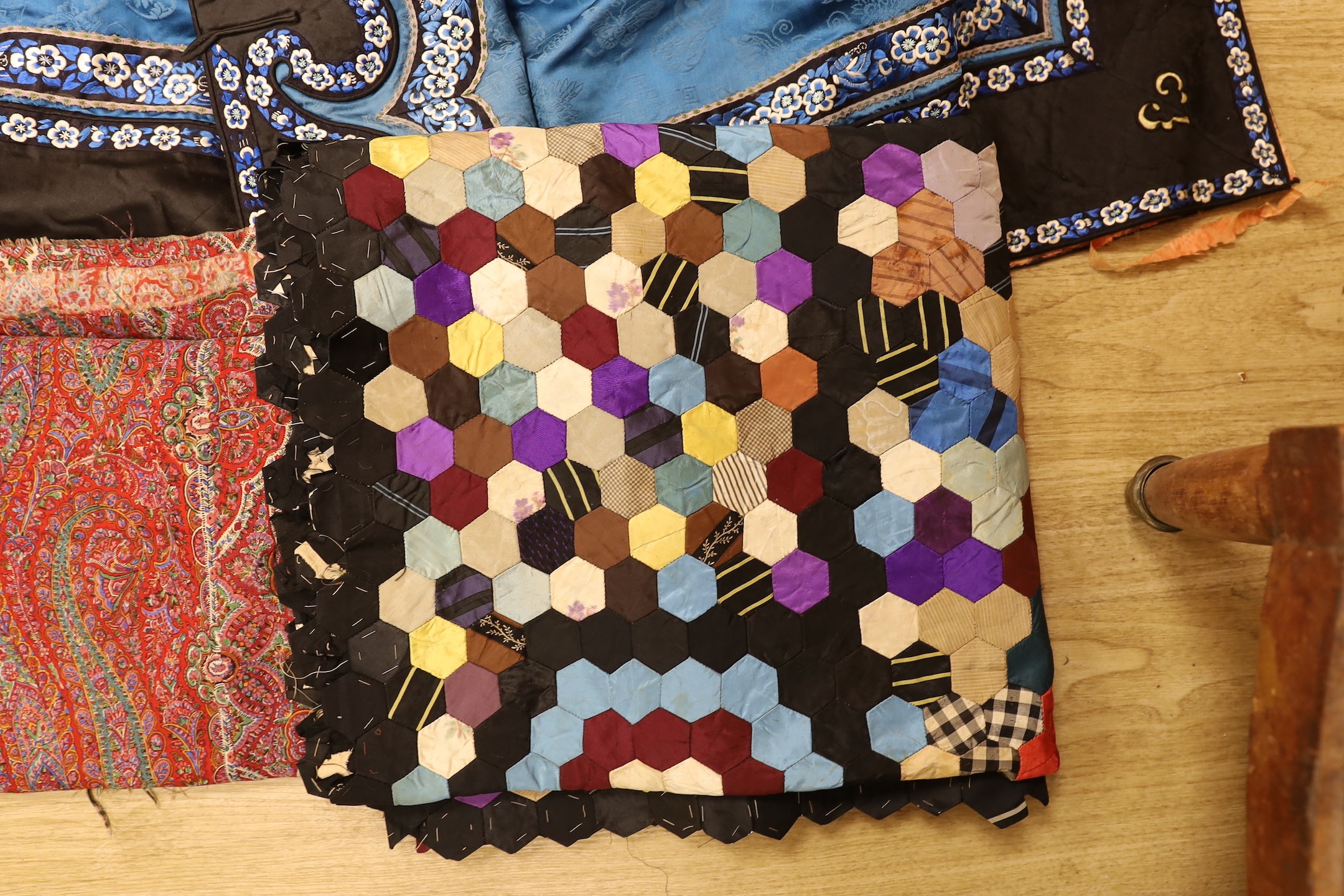 A Chinese silk robe, a 19th century patchwork panel and a panel from a Paisley summer shawl and a black parasol